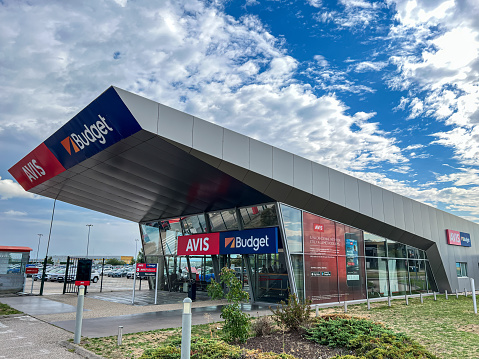 Lyon, France- August 30,2022: The office building of Avis  and Budget car rental in airport of Lyon, France. Avis Budget Group is American car rental agency holding company.