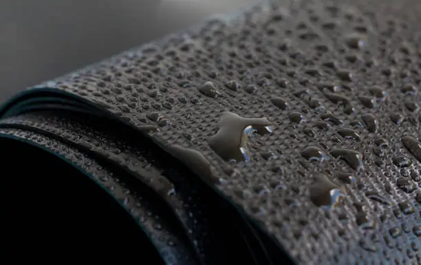 Photo of Water droplets on the rubber membrane. Waterproofing...  Close-up selective focus area.