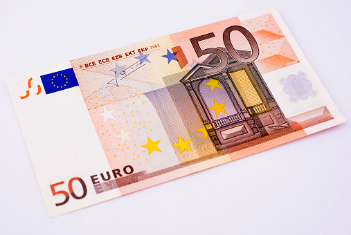 Various Euro bills in a frame composition on white background.