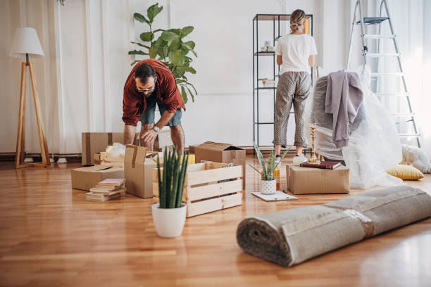 istock Couple unpacking in new home 1424605209