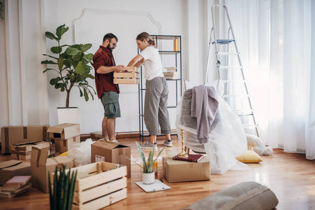 istock Couple unpacking in new home 1424605259