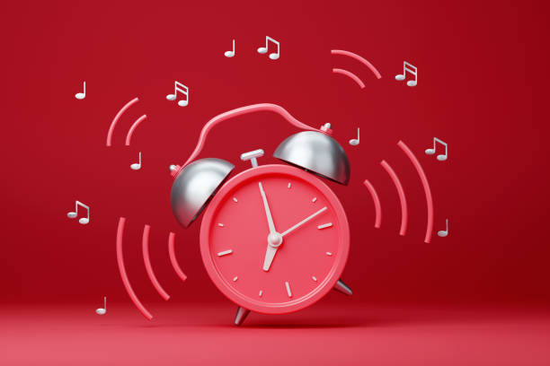 istock Red retro ringing alarm clock with sound waves on red background 1424609410