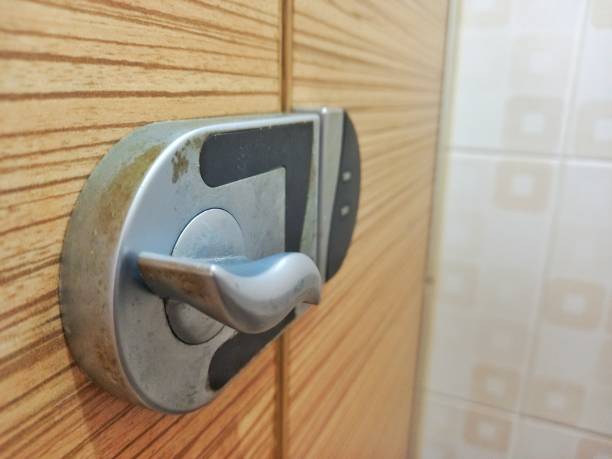 public toilet partition door panel and stainless steel door lock, with a blurred wall background - frosted glass glass textured bathroom imagens e fotografias de stock