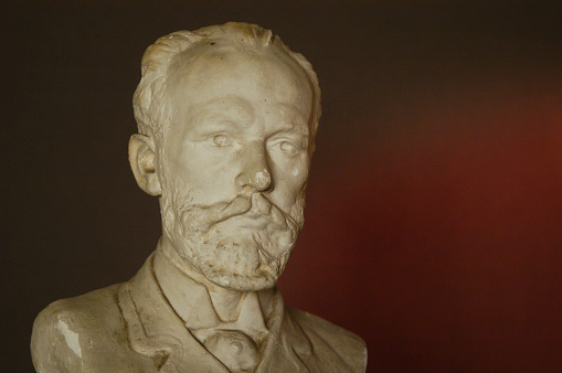 Gypsum figure of the composer Tchaikovsky in the studio with lighting and filters effect from the candle cinematographic effect