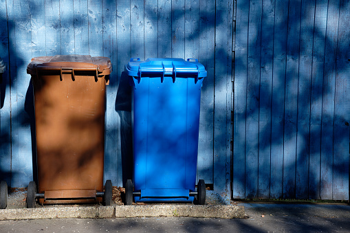 Wheelie bin colour blue, purple and black for refuge collection outside house in a row UK