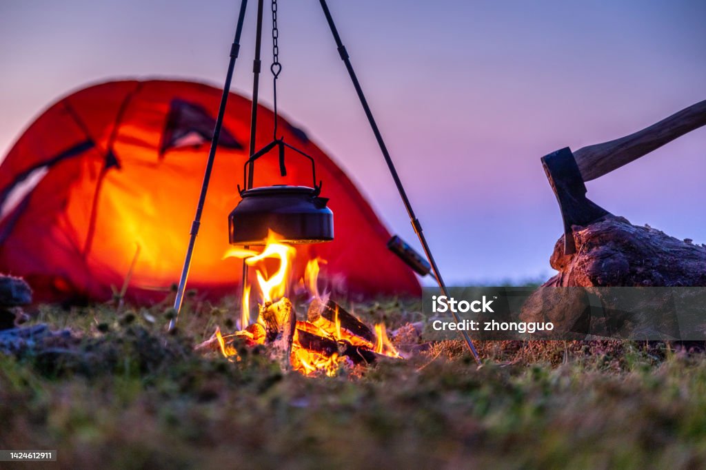 Preparing food on campfire Camping Stock Photo