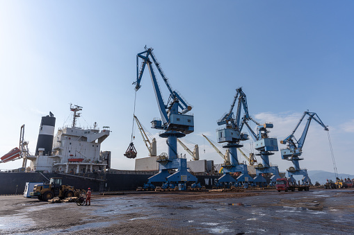 Port panorama, harbor cranes and granaries in the cargo seaport.