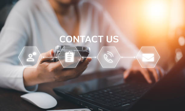 istock Communication and Contact us or Customer support hotline people connect. Hand using a laptop and touching on virtual screen contact icons, email and address, live chat with internet wifi. 1424617626