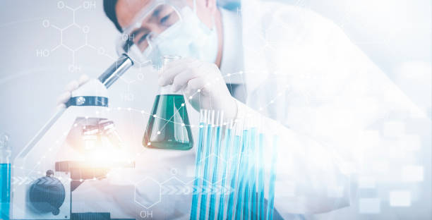 istock biochemical research scientist working with microscope for coronavirus, laboratory glassware containing chemical liquid for design or decorate science, chemistry, biology, medicine and people concept 1424617644