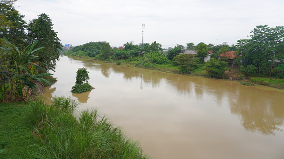 Citarum river with brown water in Karawang
