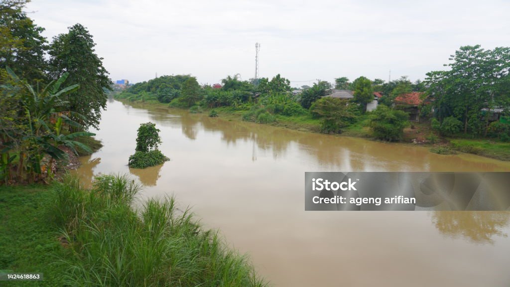 Citarum river with brown water in Karawang Agricultural Field Stock Photo