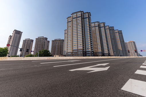 Empty asphalt road and urban residential buildings