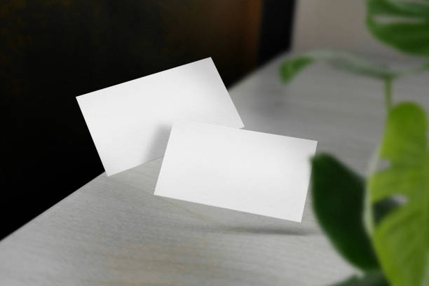 istock Clean minimal business card mockup floating on desktop with leaves 1424619777