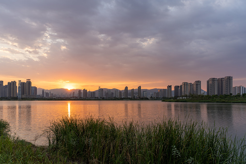 Lake and city skyline at sunset