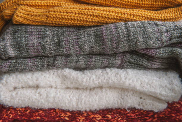 istock Autumn and winter background with knitted colourful sweaters 1424623551