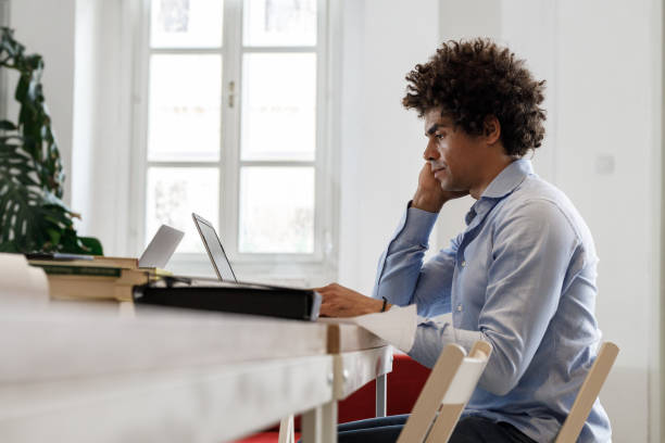 istock Casually dressed young African -american businessman is considering ideas about a new startup project. 1424623672
