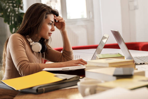 istock Casually dressed young woman is considering ideas about a new startup project.He is sitting in his office and using a laptop. 1424623705