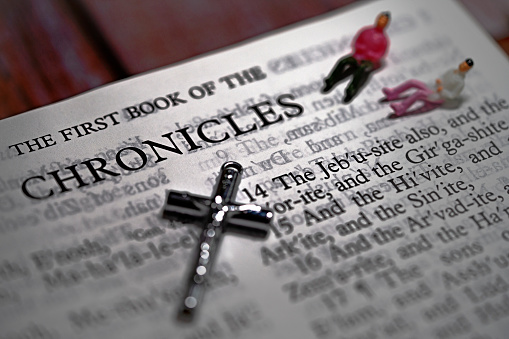 Open book of Holy Bible The First Book of the CHRONICLES and silver crucifix cross for background and inspiration