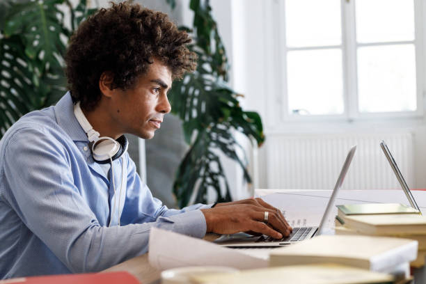 istock Casually dressed young African -american businessman is considering ideas about a new startup project. 1424623837