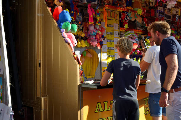 Estepona, Spain - May 18, 2013: Parents attend their kids at a carousel ride in the evening. May fair of Estepona (Feria de Mayo de Estepna) in Andalusia Spain