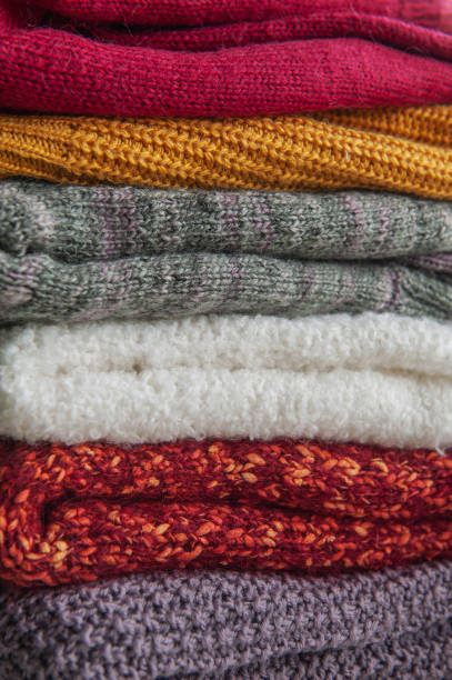 istock Autumn and winter background with knitted colourful sweaters 1424624911