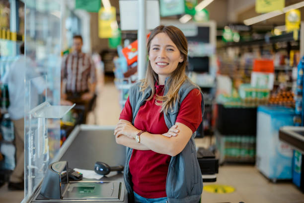 istock Smiling Female Cashier Looking at Camera 1424626842