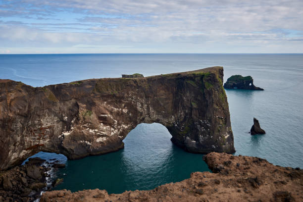 istock Rock arch in the Atlantic ocean at Dyrholaey peninsula, Vik 1424627117