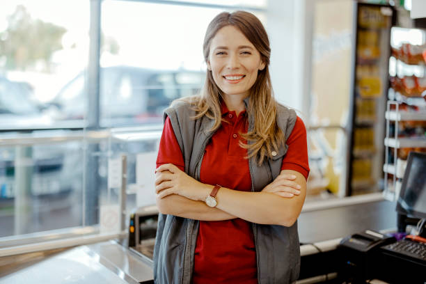 istock Smiling Female Cashier Looking at Camera 1424627157