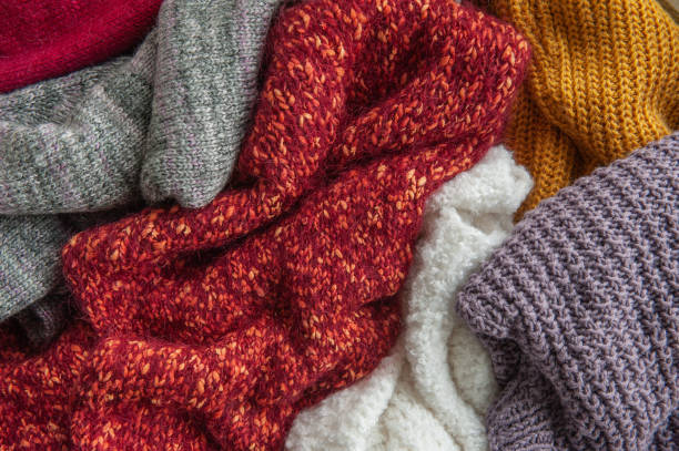 istock Autumn and winter background with knitted colourful sweaters 1424627841