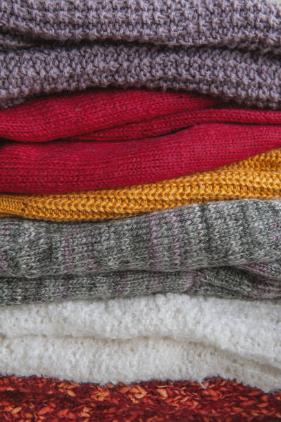 istock Autumn and winter background with knitted colourful sweaters 1424628755