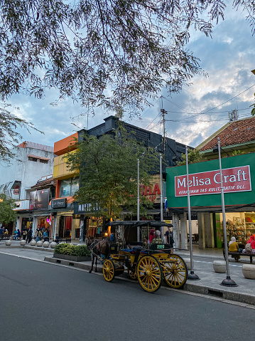 Yogyakarta, Indonesia - September 15, 2022: Malioboro street tourism is alive again with many tourists, traders and shops and the place is getting neater and cleaner
