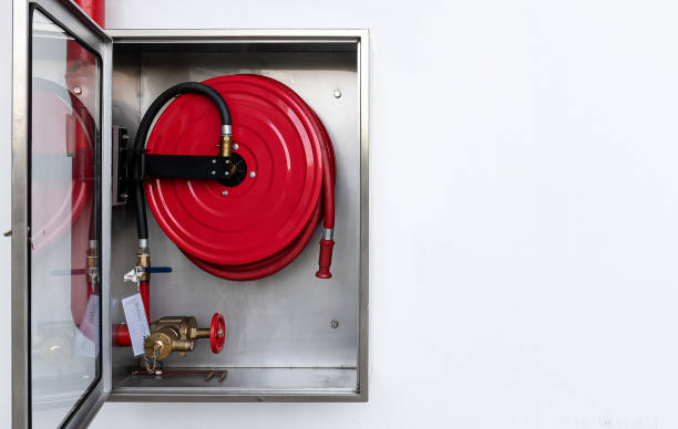 istock Cabinet open door with fire hose reel inside and copy space 1424630824