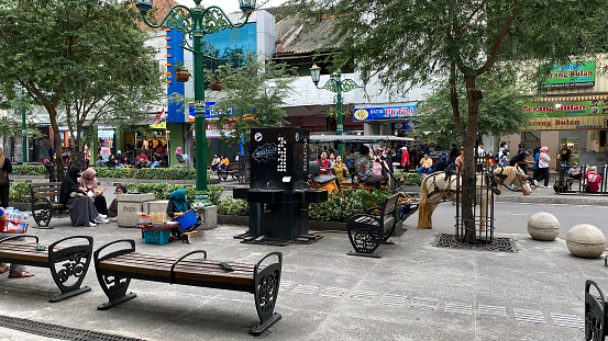 Yogyakarta, Indonesia - September 15, 2022: Malioboro street tourism is alive again with many tourists, traders and shops and the place is getting neater and cleaner