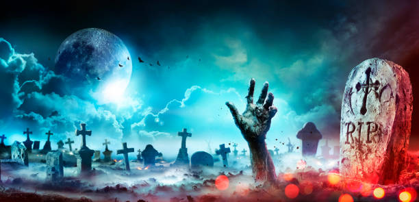 Zombie Hand Rising Out Of A Graveyard At Night With Full Moon stock photo