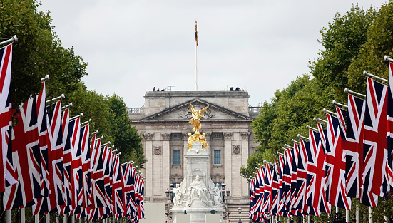 London, UK - September 14, 2022: Union Jack flags along the Mall and Buckingham Palace on the day of the royal procession of  Queen Elizabeth II's coffin to Westminster Hall.