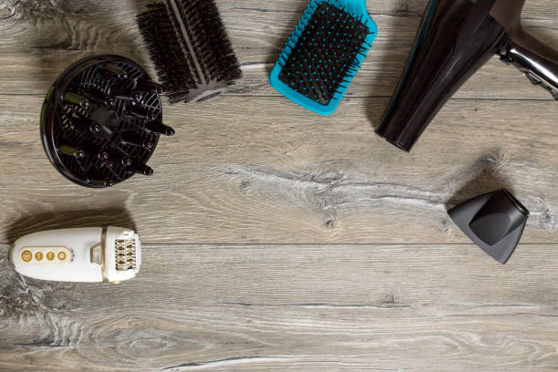 istock Hairdressing tools on wooden background with copy space at top 1424641310