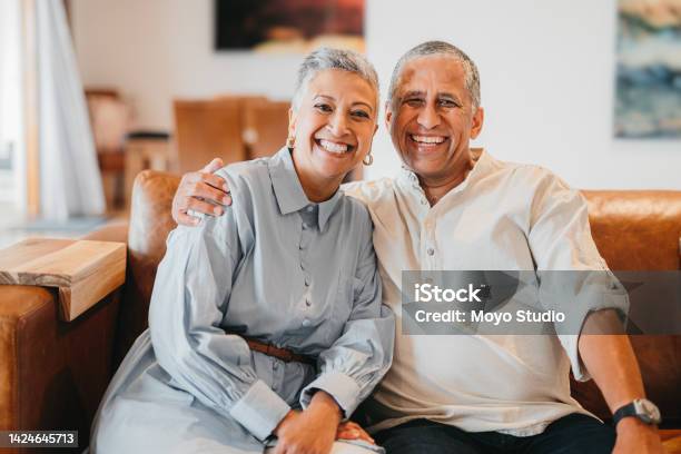 Freedom Retirement And A Happy Elderly Couple Hug And Relax On A Sofa In A Living Room At Home Together Portrait Of Loving Senior Husband And Wife Laughing Content And Enjoying Their Free Time Stock Photo - Download Image Now