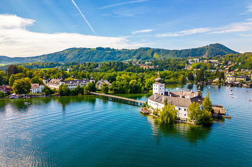 Gmunden, Austria - 6.9.2022: Schloss Ort (or Schloss Orth) is an Austrian castle situated in the Traunsee lake, in Gmunden. Aerial drone view.