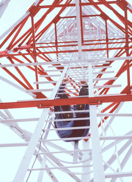 istock Professional industrial climber is climbing a high power electric line tower 1424646840