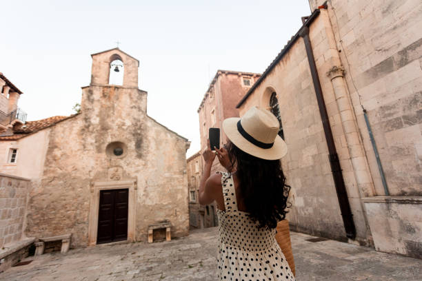 istock Woman taking picture with her mobile phone 1424648617