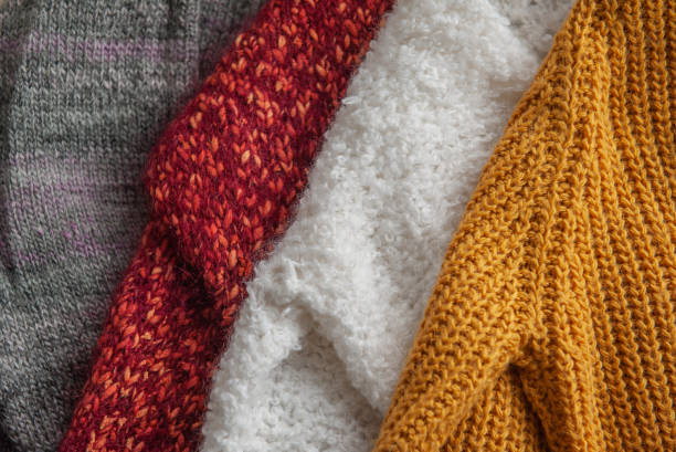 istock Autumn and winter background with knitted colourful sweaters 1424649631