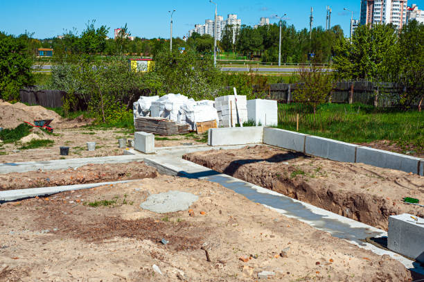 istock Reinforced concrete foundation of a modern monolithic residential building. Prepared formwork with reinforcing mesh for pouring concrete. Dirt and clay at the construction site 1424650175