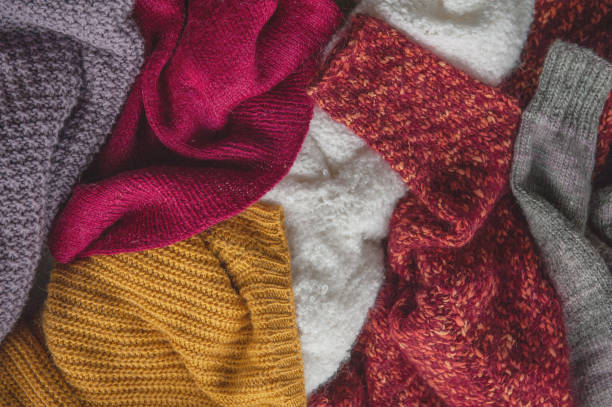 istock Autumn and winter background with knitted colourful sweaters 1424650321