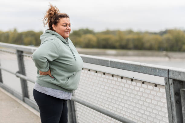 istock Obese Latin woman taking a break after outside exercise 1424650580