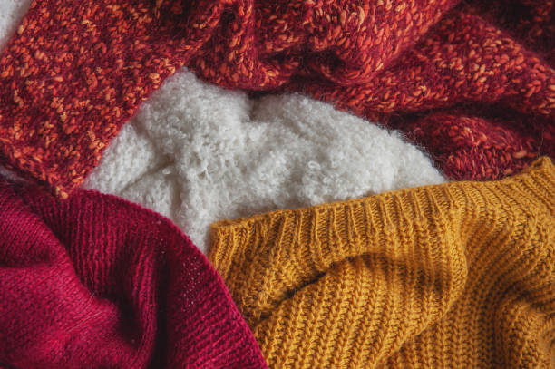 istock Autumn and winter background with knitted colourful sweaters 1424650920