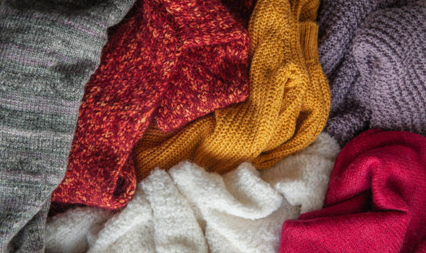 istock Autumn and winter background with knitted colourful sweaters 1424653116