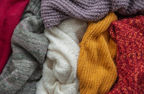 istock Autumn and winter background with knitted colourful sweaters 1424654193