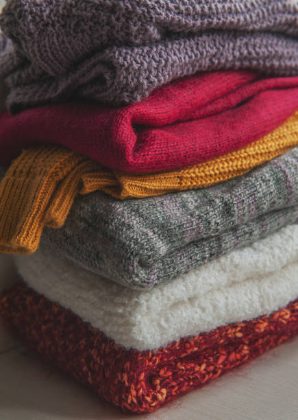 istock Autumn and winter background with knitted colourful sweaters 1424655147