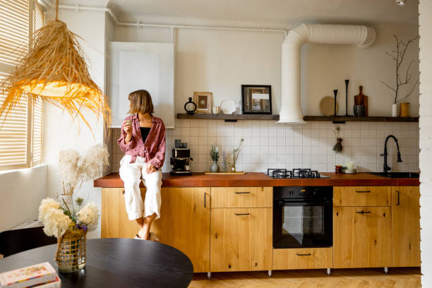 istock Modern kitchen interior with person sitting on table top 1424659706