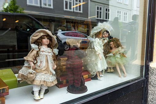 Haugesund Harbour and harbour side buildings, Norway.  This is a giftshop window with old fashioned dolls in the window.